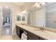 Bathroom featuring a double sink vanity with granite countertops, a toilet, and a tiled glass-enclosed shower at 24193 Gallberry Dr, Venice, FL 34293