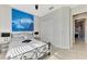 Bright bedroom with large decorative painting above the bed and direct access to the en-suite bathroom at 24193 Gallberry Dr, Venice, FL 34293