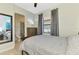 Bedroom featuring a full-size bed, ceiling fan, with an adjacent bathroom with glass shower at 24193 Gallberry Dr, Venice, FL 34293