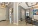 Home entryway featuring high ceilings, tile flooring, an open concept, and a stylish chandelier at 24193 Gallberry Dr, Venice, FL 34293