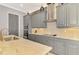 Close-up of modern kitchen with granite countertops, stainless steel appliances, and gray cabinets at 24193 Gallberry Dr, Venice, FL 34293