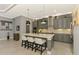 Modern kitchen with a large island, pendant lighting, and stainless-steel appliances at 24193 Gallberry Dr, Venice, FL 34293