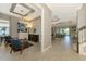 Elegant living room with high ceilings, tiled floors, and a view of the backyard and pool at 24193 Gallberry Dr, Venice, FL 34293