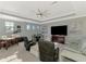 Spacious living room with a ceiling fan, large TV, and dining area for entertaining at 24193 Gallberry Dr, Venice, FL 34293