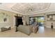 Comfortable living area featuring a modern ceiling fan, tile floors, neutral tones and access to the lanai at 24193 Gallberry Dr, Venice, FL 34293