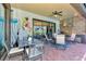 Covered patio with outdoor dining, grill and lounge area, creating the perfect space for relaxation and entertainment at 24193 Gallberry Dr, Venice, FL 34293