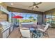 Covered outdoor kitchen and lounge area offering serene pool views, perfect for entertaining or relaxation at 24193 Gallberry Dr, Venice, FL 34293
