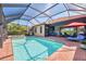 Sparkling pool with screened enclosure and ample patio space, perfect for enjoying the Florida sunshine at 24193 Gallberry Dr, Venice, FL 34293