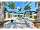 Outdoor spa area with a pergola, seating, and lush landscaping, perfect for relaxation at 24193 Gallberry Dr, Venice, FL 34293