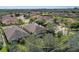 A panoramic view of a suburban neighborhood with many homes, green spaces, and trees at 2542 Cortenova Ct, Venice, FL 34292