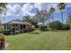 Backyard view featuring a screened-in lanai and well-maintained lawn, highlighting the property's outdoor amenities at 2542 Cortenova Ct, Venice, FL 34292