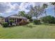 Backyard view featuring a screened-in lanai and well-maintained lawn, highlighting the property's outdoor amenities at 2542 Cortenova Ct, Venice, FL 34292