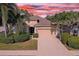 Charming single Gathering home featuring a two-car garage, mature landscaping, and a welcoming entrance at 2542 Cortenova Ct, Venice, FL 34292