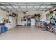 Spacious garage featuring ample storage, a refrigerator, and a dining area at 2542 Cortenova Ct, Venice, FL 34292