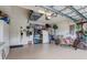 Spacious garage featuring ample storage, a refrigerator, and a dining area at 2542 Cortenova Ct, Venice, FL 34292
