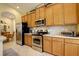 Spacious kitchen with stainless steel appliances, tile backsplash, and plenty of cabinet space, adjacent to a dining area at 2542 Cortenova Ct, Venice, FL 34292