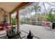 Spacious screened lanai with seating, offering relaxation and views of the surrounding greenery at 2542 Cortenova Ct, Venice, FL 34292