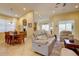 Open living space featuring dining area, comfortable seating, and tile flooring at 2542 Cortenova Ct, Venice, FL 34292