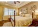 Serene bedroom featuring natural light, a decorative ceiling fan, and neutral decor at 2542 Cortenova Ct, Venice, FL 34292