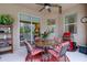 Outdoor patio featuring a ceiling fan, grill, table with four chairs, and sliding glass doors leading to the home at 2542 Cortenova Ct, Venice, FL 34292