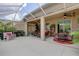 Expansive screened-in lanai with dining and lounge areas, featuring tropical plants and comfortable outdoor furniture at 2542 Cortenova Ct, Venice, FL 34292