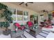 Relaxing outdoor patio with wicker seating, ceiling fans, and views of the garden, perfect for entertaining or unwinding at 2542 Cortenova Ct, Venice, FL 34292