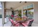 Covered lanai with comfortable seating overlooking the backyard at 2542 Cortenova Ct, Venice, FL 34292