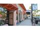 A charming street view of storefronts with awnings and decorative columns offers shopping and dining at 2542 Cortenova Ct, Venice, FL 34292
