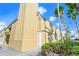 Angle view of the Venice Theatre, with palm trees enhancing the building and a quaint garden in the front at 2542 Cortenova Ct, Venice, FL 34292