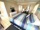 Comfortable bedroom with tile flooring, a modern dresser, and a neatly made bed with blue and teal accents at 262 Mariner Dr, North Port, FL 34287