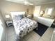 Bright bedroom featuring a comfortable bed with beach-themed linens and white wicker furniture at 262 Mariner Dr, North Port, FL 34287