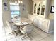 Bright dining area with a built-in cabinet and seating for four at 262 Mariner Dr, North Port, FL 34287