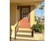 Home entrance with stairs and railing leading to front door and trimmed hedges at 262 Mariner Dr, North Port, FL 34287