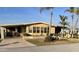 Well-maintained single-story residence with a covered carport and landscaped front yard at 262 Mariner Dr, North Port, FL 34287
