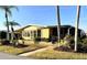 Charming single-story home featuring mature landscaping and a welcoming front porch at 262 Mariner Dr, North Port, FL 34287