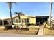 Inviting single-story home showcases lush tropical landscaping and a quaint, covered porch at 262 Mariner Dr, North Port, FL 34287