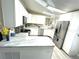 Contemporary kitchen features stainless steel appliances, light countertops and white cabinetry at 262 Mariner Dr, North Port, FL 34287