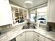 Kitchen sink view with white cabinets, light countertops, decorations and golf-cart view at 262 Mariner Dr, North Port, FL 34287