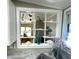 Kitchen window features decorative shelving and stainless steel sink, with light countertops at 262 Mariner Dr, North Port, FL 34287