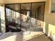 Enclosed patio with outdoor seating, view into the backyard and access to the house at 262 Mariner Dr, North Port, FL 34287