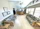 Wide view of the sunroom with wicker seating and bar area at 262 Mariner Dr, North Port, FL 34287