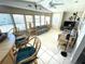 Bright sunroom featuring large windows, neutral furniture, and ceiling fan at 262 Mariner Dr, North Port, FL 34287