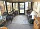 Inviting sunroom featuring comfortable wicker seating, glass table, and ample natural light at 262 Mariner Dr, North Port, FL 34287