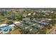 An aerial view of tennis courts with a nearby pool and golf course, offering diverse recreational options at 269 Southampton Dr # 303, Venice, FL 34293