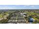 Aerial view featuring tennis courts amidst lush greenery and community amenities, showcasing an active lifestyle at 269 Southampton Dr # 303, Venice, FL 34293
