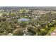A tranquil aerial scene of homes nestled around a lake and golf course, showcasing a serene community at 269 Southampton Dr # 303, Venice, FL 34293