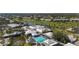 Overhead view of a pool and recreational facilities with golf course in background, perfect for leisure at 269 Southampton Dr # 303, Venice, FL 34293