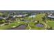 An aerial of a sprawling golf course with ponds and residential areas, highlighting community amenities at 269 Southampton Dr # 303, Venice, FL 34293
