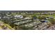 Aerial view showcasing tennis courts with golf course in the background for community recreation at 269 Southampton Dr # 303, Venice, FL 34293