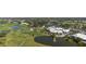 Detailed aerial view of the golf course and community center with pool and tennis courts at 269 Southampton Dr # 303, Venice, FL 34293